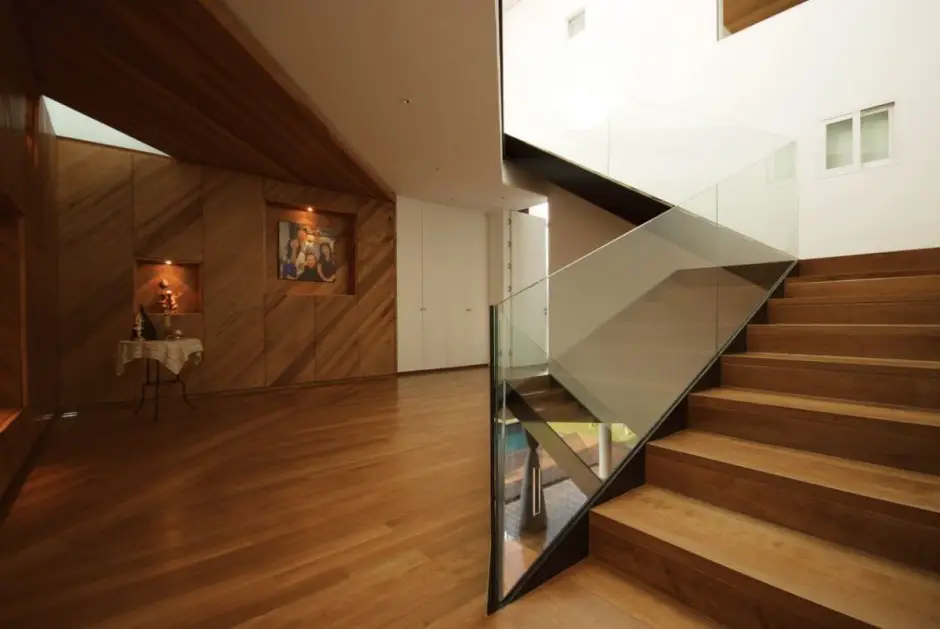 Staircase Area with Built in Wall Decorative Item Display and Glass Balustrade