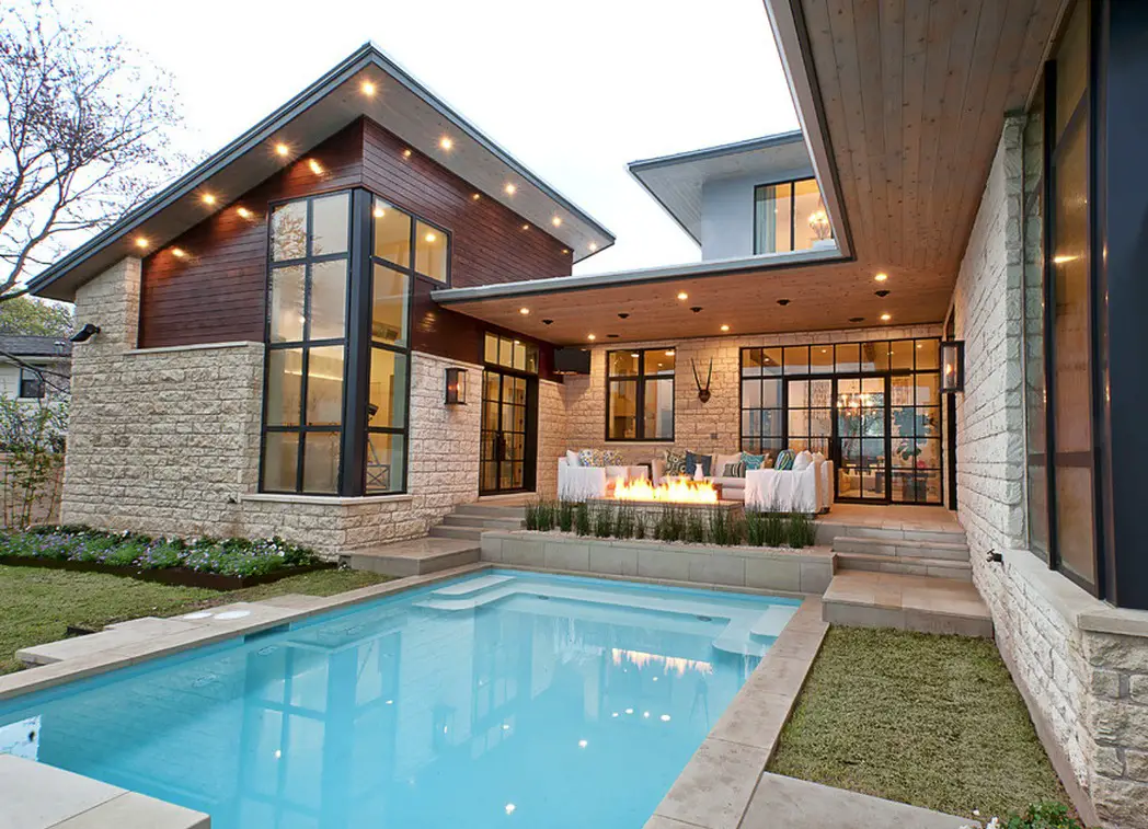 Home Pool Area with White Sofas and Long Fire Pit under Wooden Ceiling